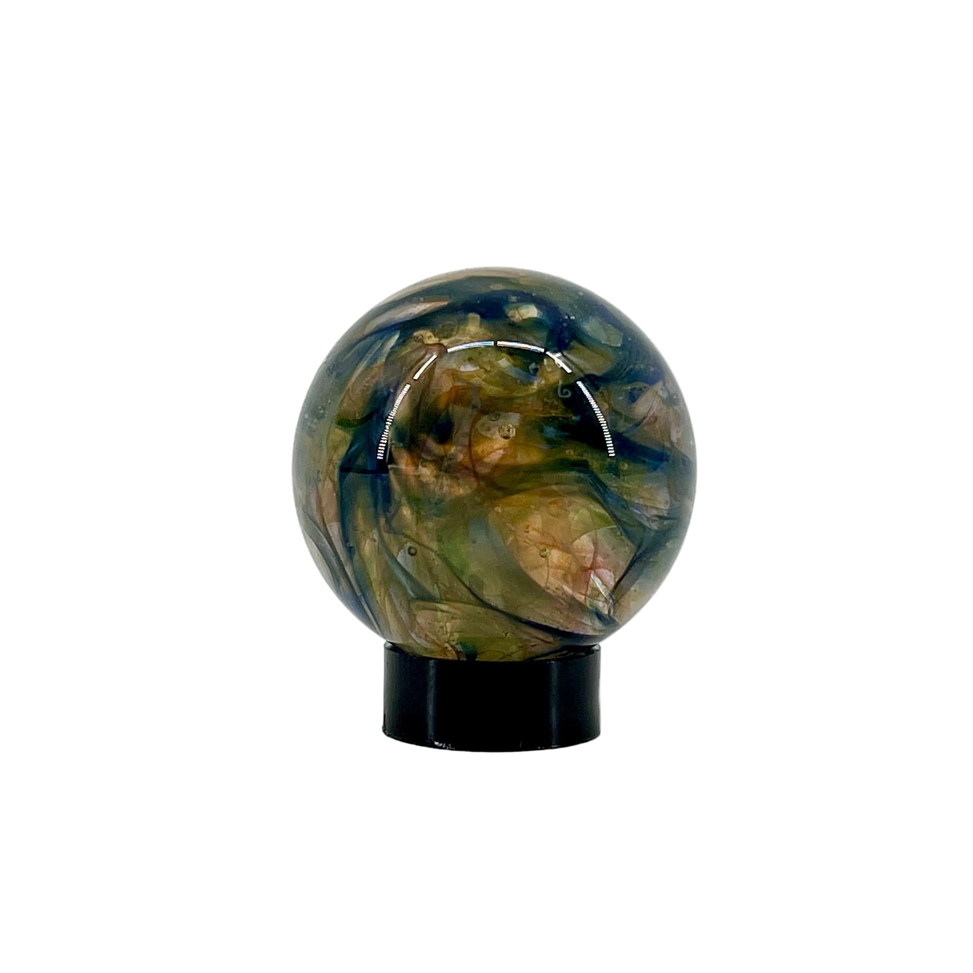 Decorative glass sphere with a black base on a white background