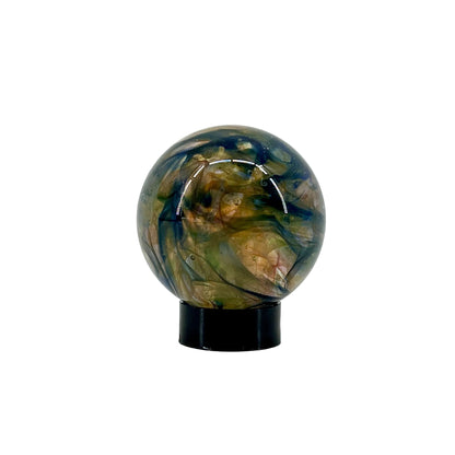 Decorative glass sphere with a black base on a white background