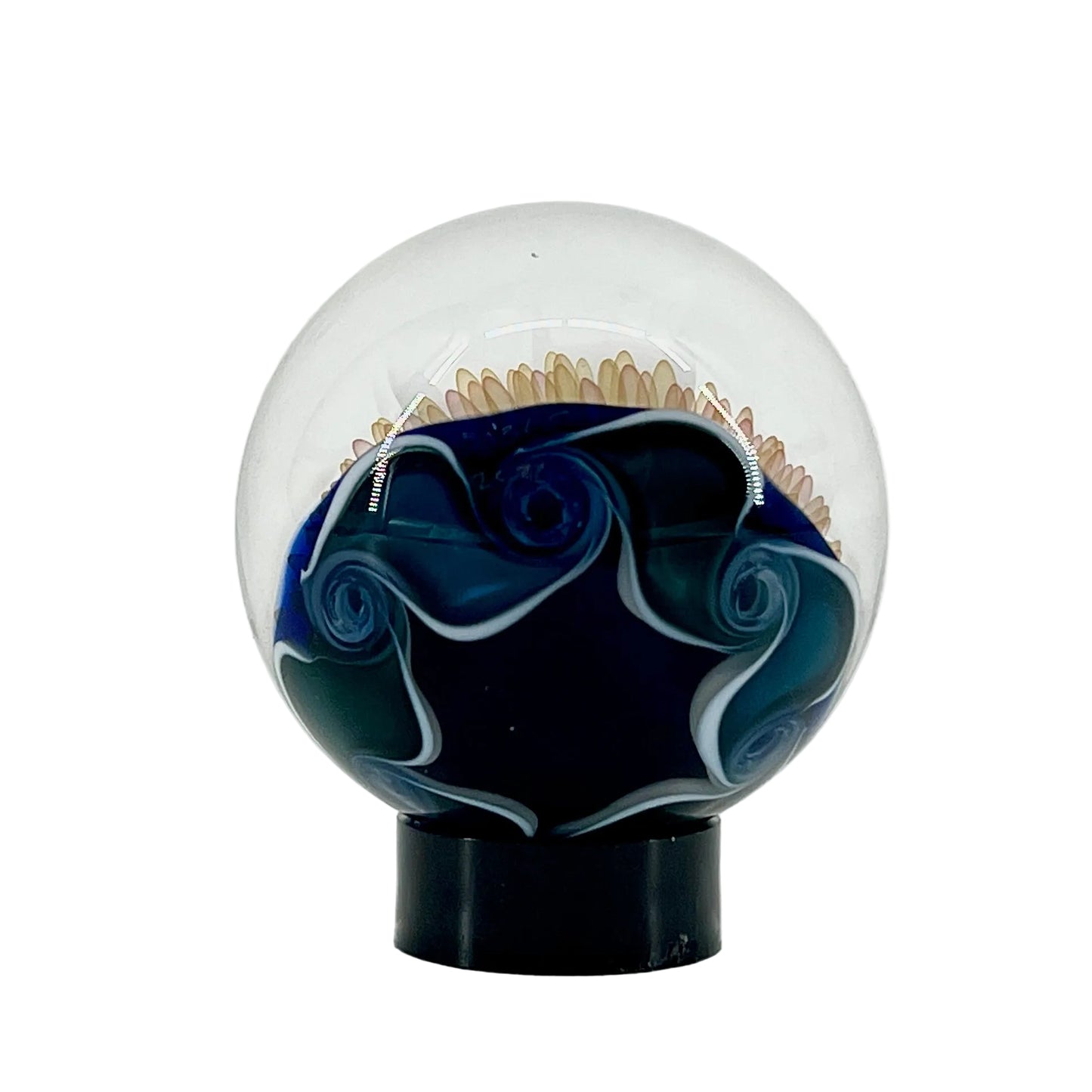 Decorative glass sphere with blue and white design on a white background