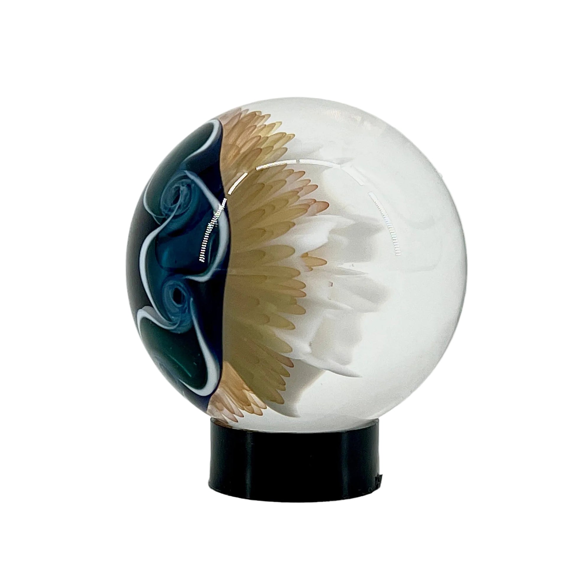 Decorative glass sphere with artistic design on a white background