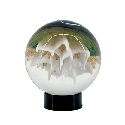 Glass sphere with a jellyfish inside on a white background
