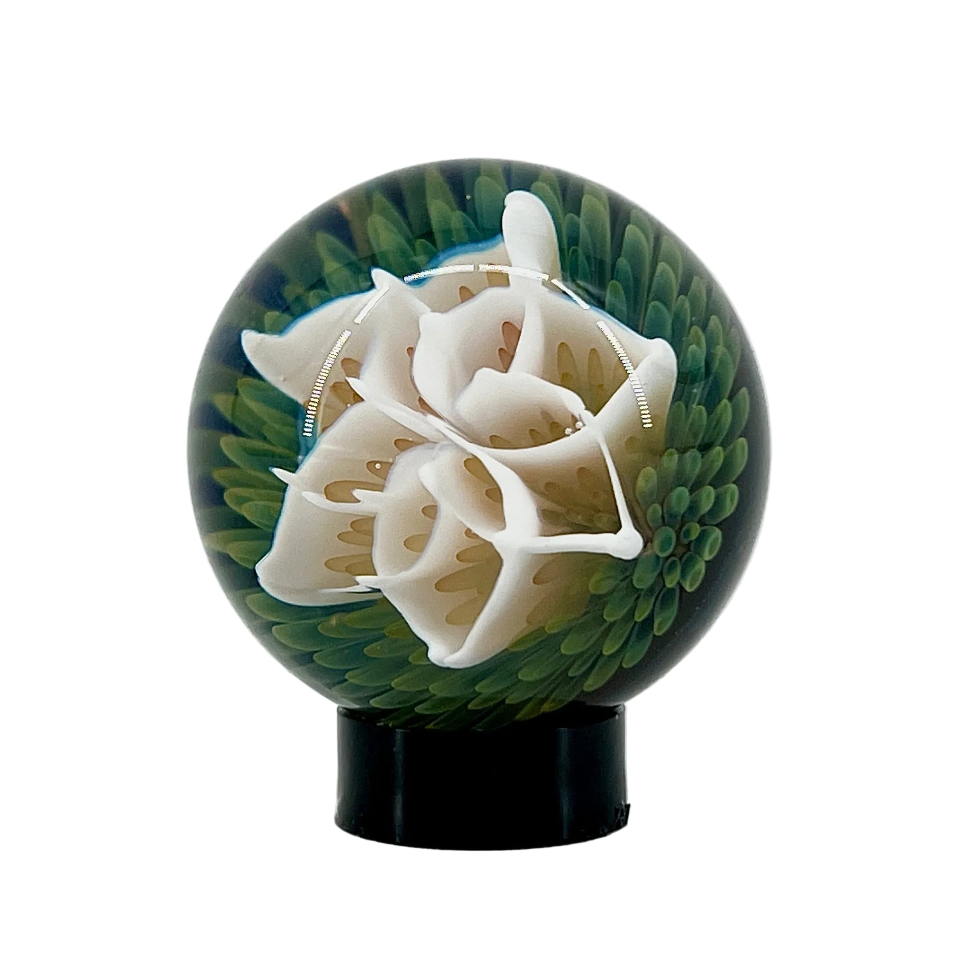 Decorative sphere with white floral design on a green background
