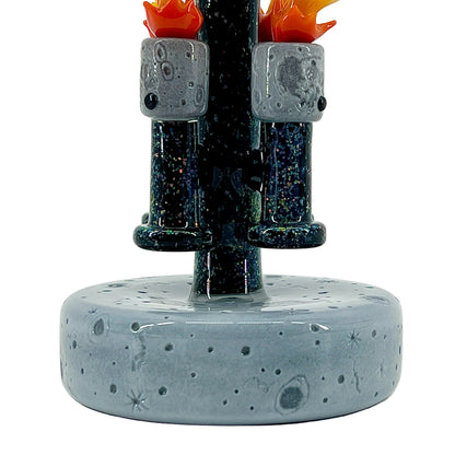 Glass sculpture with a textured base and abstract design on a white background.