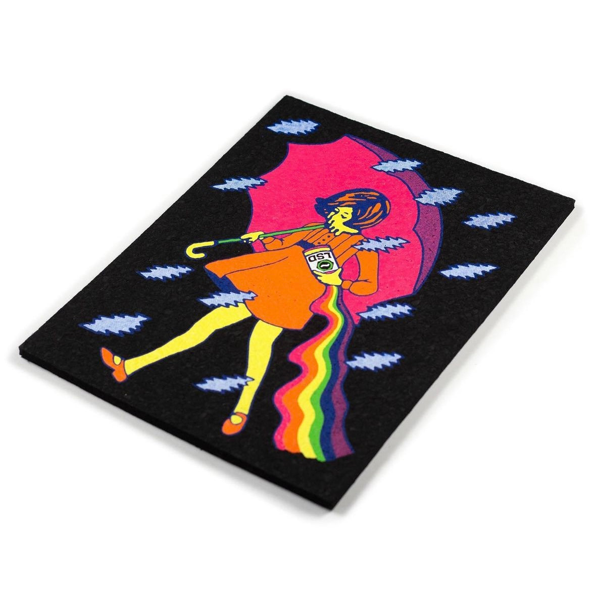A colorful mat featuring an illustrated character with a red dress and umbrella, against a black background with lightning bolts.