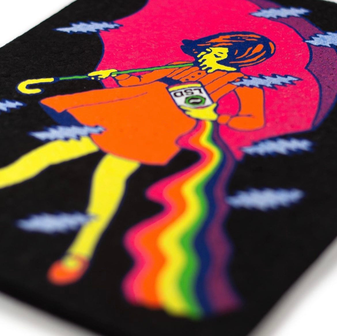 A colorful mat featuring an illustrated character with a red dress and umbrella, against a black background with lightning bolts.