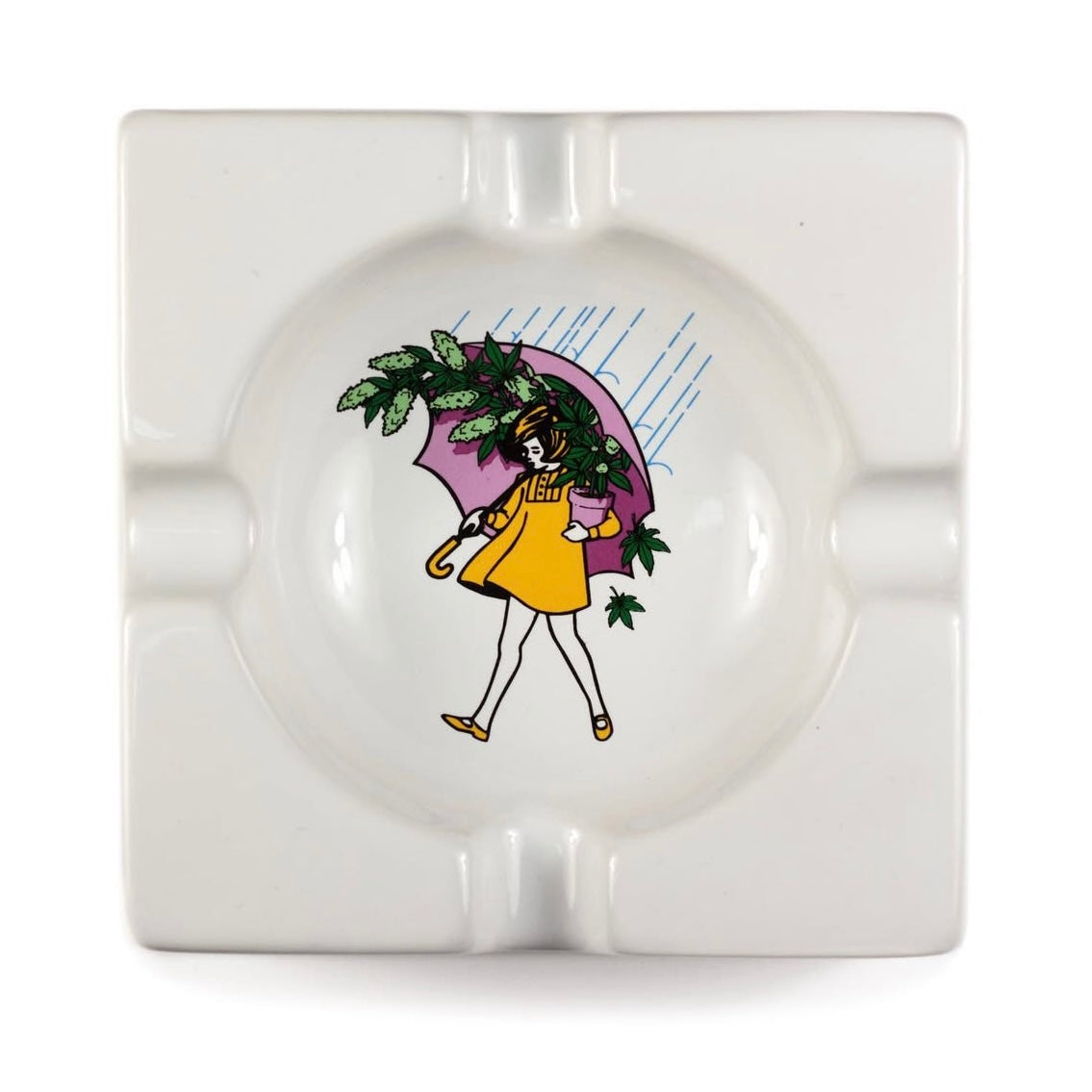 White ceramic ashtray with a decorative design of a person holding an umbrella and plants on a white background.