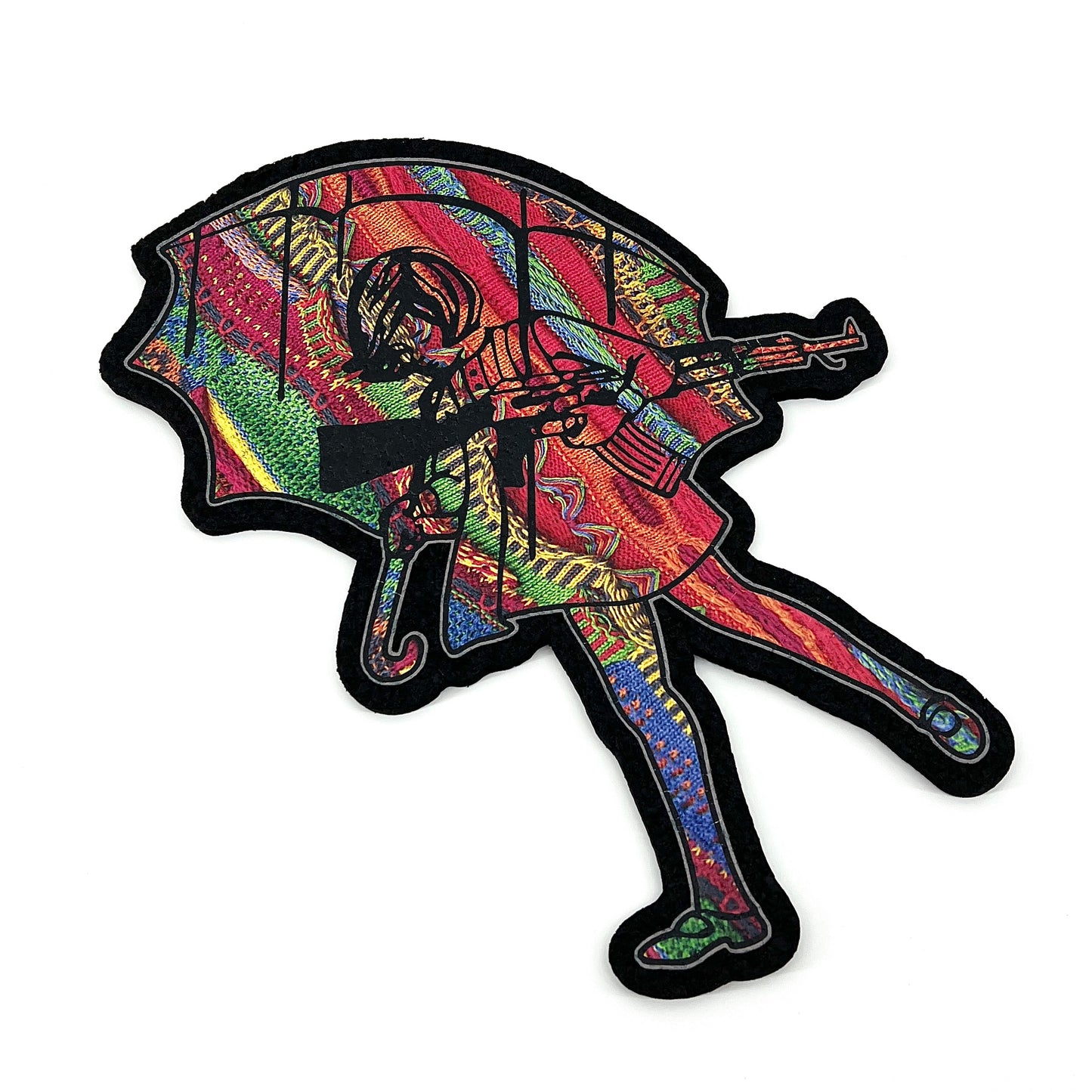 A multicolored, geometric-patterned mat featuring a stylized, abstract character holding an umbrella.