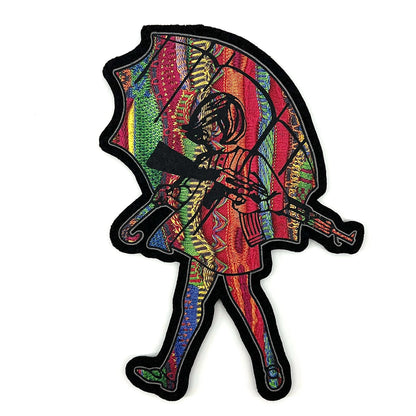 A multicolored, geometric-patterned mat featuring a stylized, abstract character holding an umbrella.