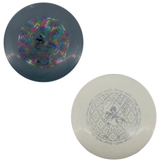 Two disc golf discs, one gray with colorful design and one white with black design, on a white background.