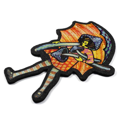 A colorful mat featuring an illustrated character with a whimsical design, predominantly orange and black, reminiscent of a mushroom.