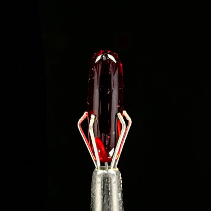 A set of three Phase Glass pieces with a swirling multicolor design, including a cap plug, valve marble, and pillar.