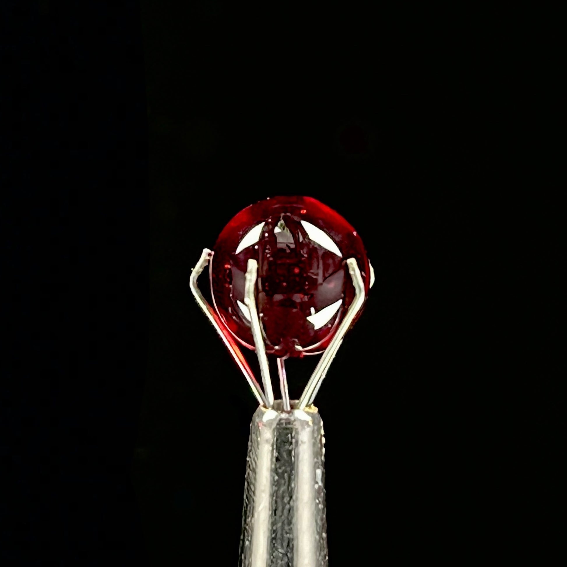 A set of three Phase Glass pieces with a swirling multicolor design, including a cap plug, valve marble, and pillar.