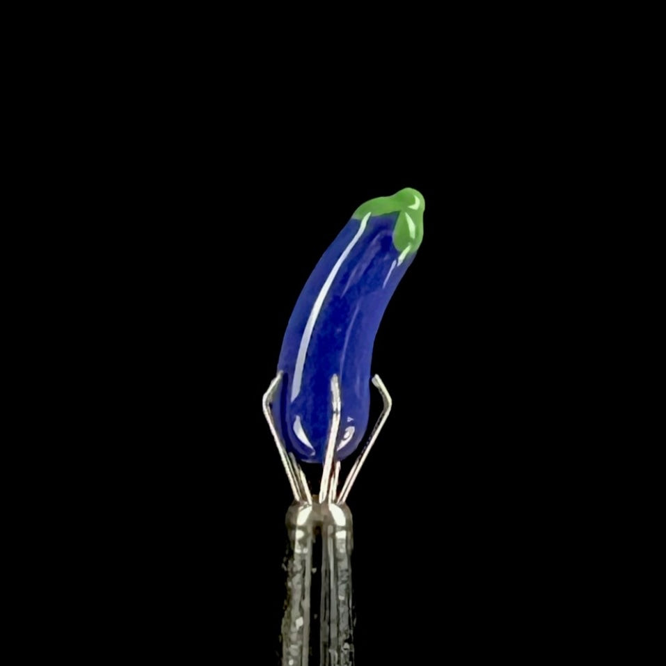 Purple glass eggplant-shaped pillar with green accents.