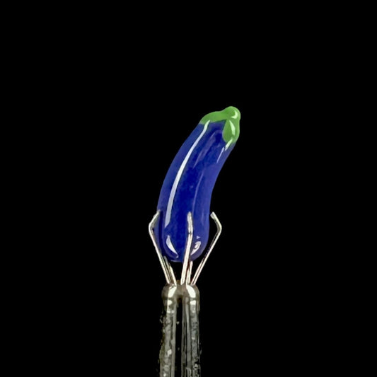 Purple glass eggplant-shaped pillar with green accents.
