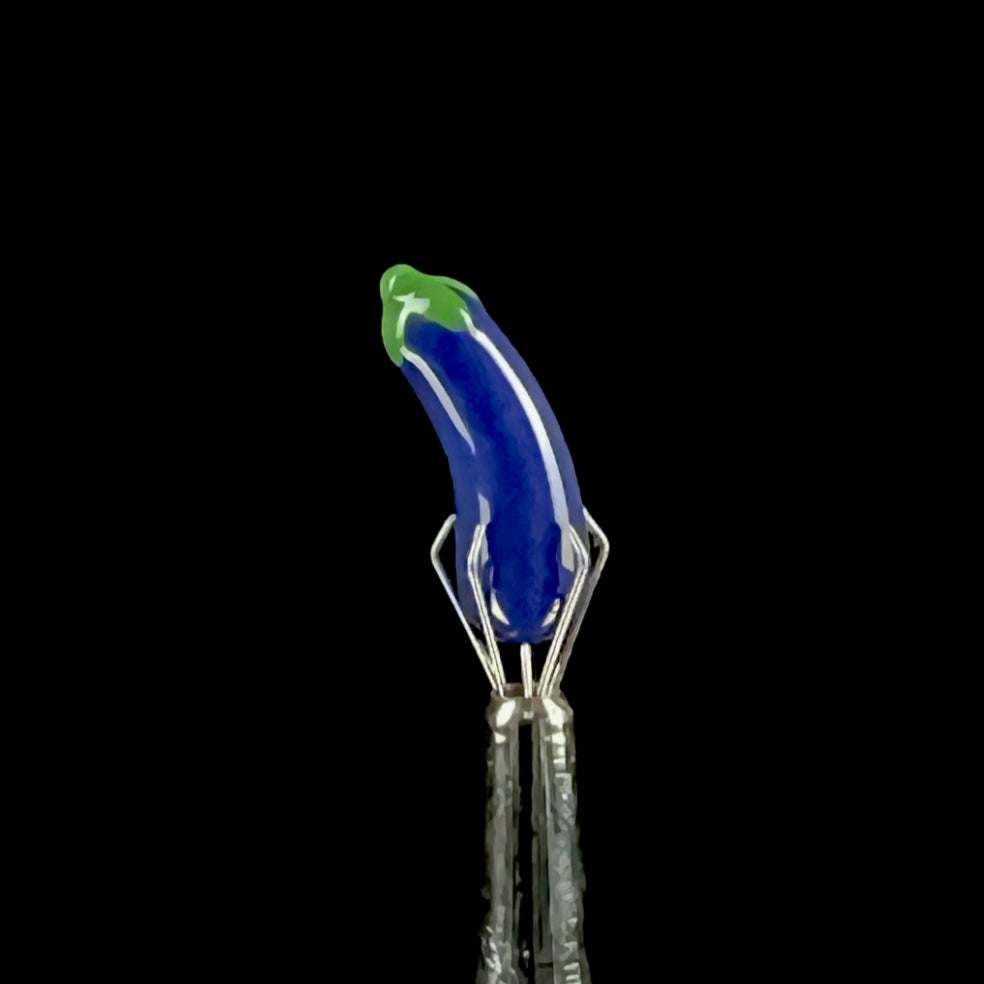 Purple glass eggplant-shaped pillar with green accents.