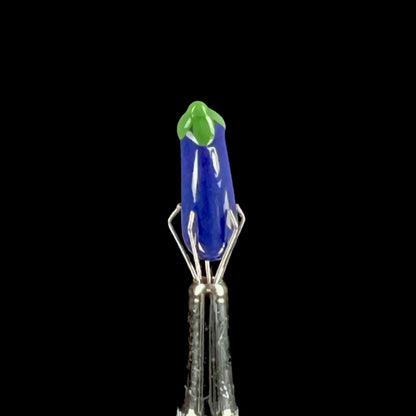 Purple glass eggplant-shaped pillar with green accents.