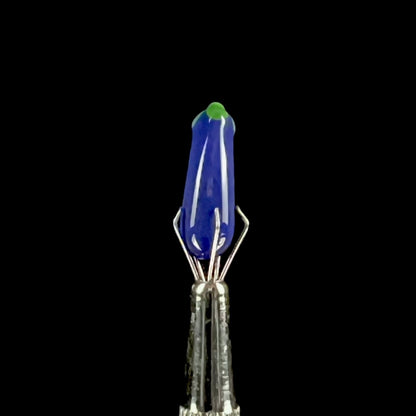 Purple glass eggplant-shaped pillar with green accents.