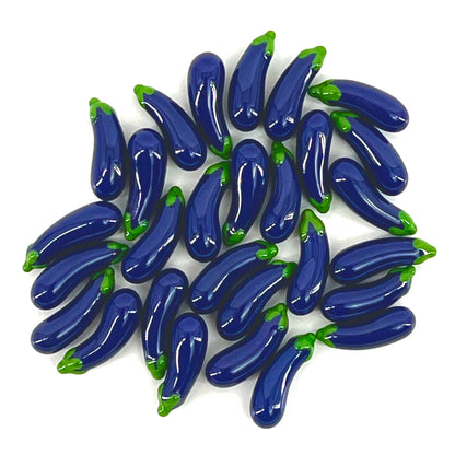 A collection of purple glass eggplant-shaped pillars with green accents.