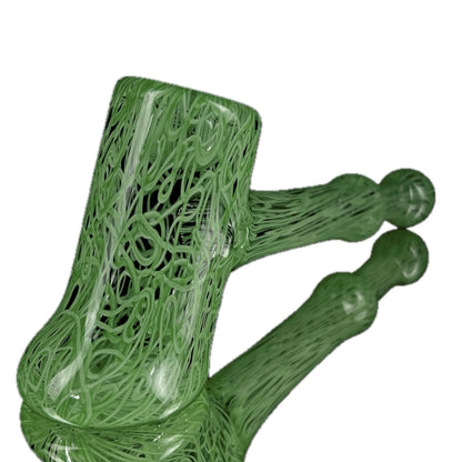 A jade green glass hand pipe with intricate patterns.
