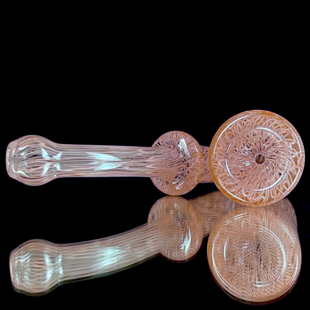 A red glass pipe with a intricate pattern, featuring a bowl and a curved stem.