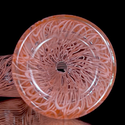 A red glass pipe with a intricate pattern, featuring a bowl and a curved stem.