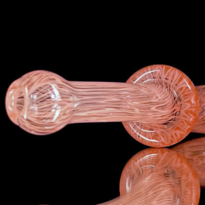 A red glass pipe with a intricate pattern, featuring a bowl and a curved stem.