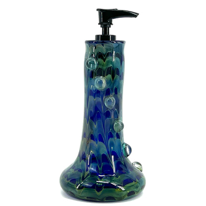 A blue glass soap dispenser with a pump, featuring bubble patterns in shades of blue and green.