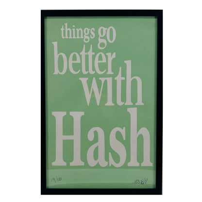 A framed print with the text 'things go better with Hash' on a green background, indicating a limited edition release by Wookerson Studios.