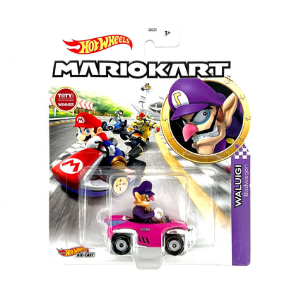 A die-cast toy car replica of Waluigi's vehicle from Mario Kart, in pink color with character details and branding.