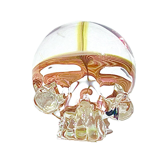 Glass skull with fumed design on a white background