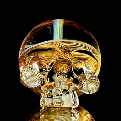 Fumed skull-shaped object on a black background