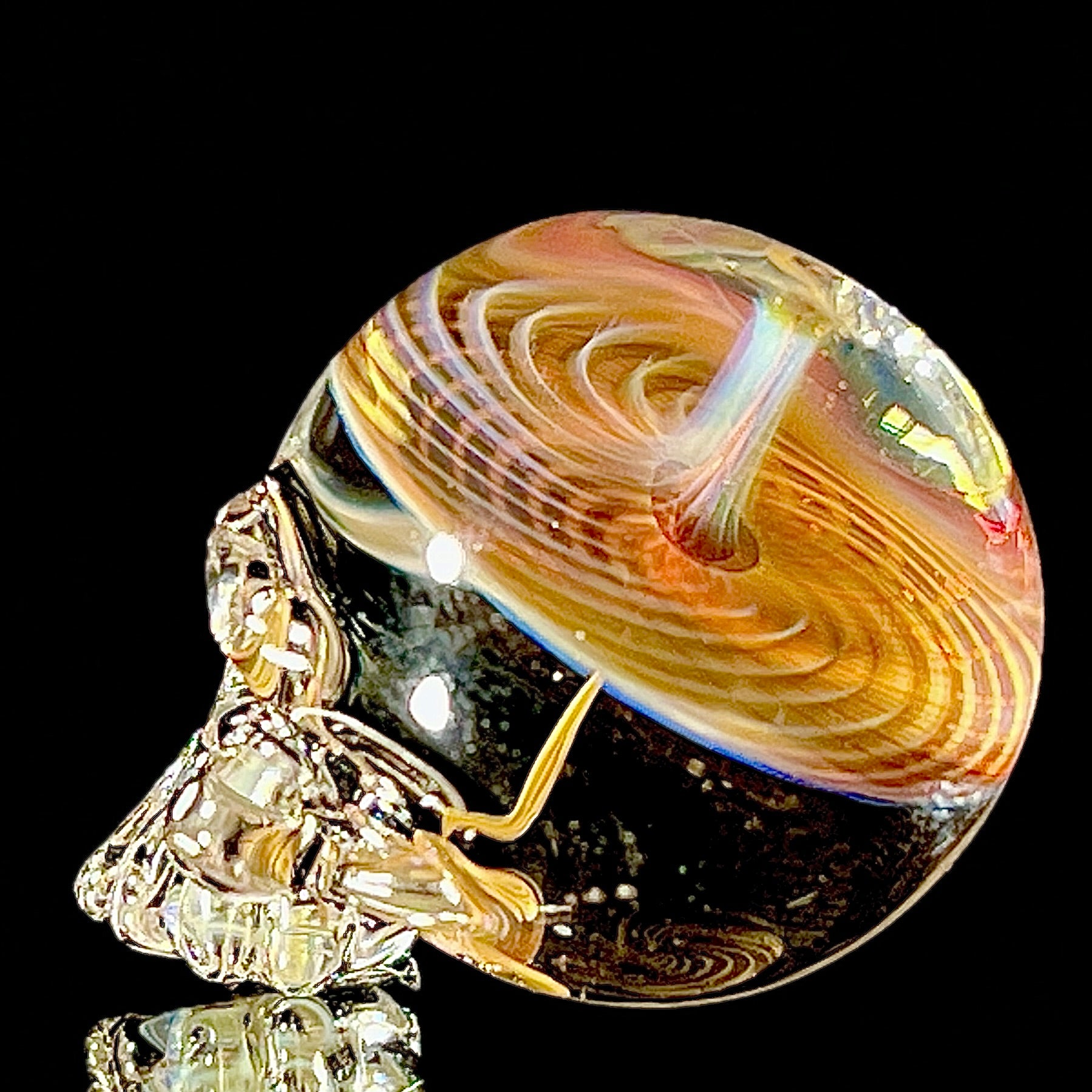 Glass skull with a fume spiral on a black background