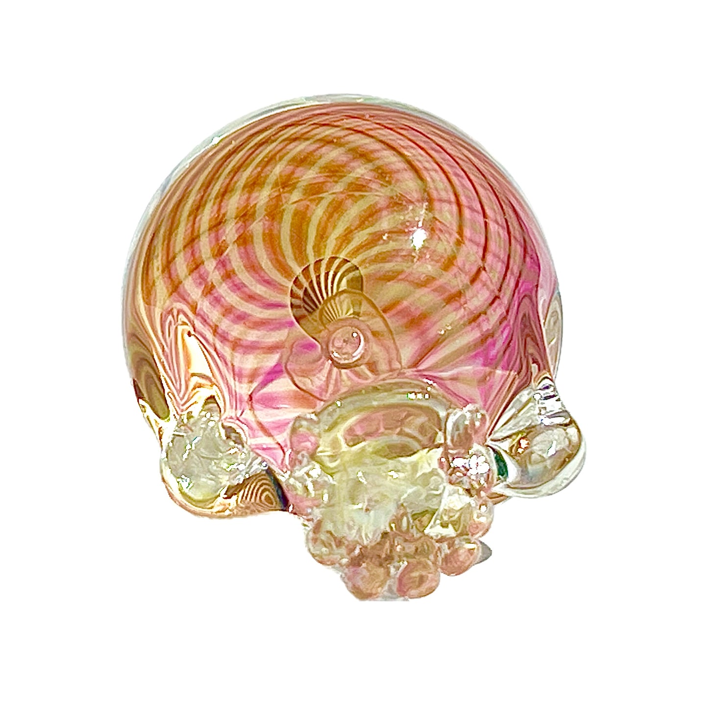 Glass sculpture of a skull with pink and gold swirls on a white background.