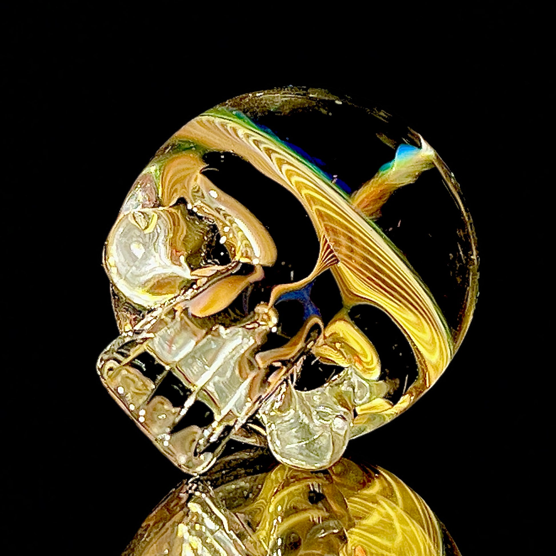 glass skull marble with fume vortex designs on a black background