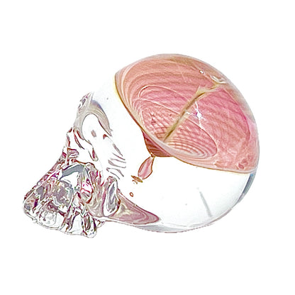 Glass sculpture of a skull on a white background