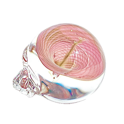 Pink vortex inside a clear glass skull on a white background
