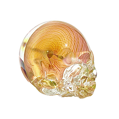 Glass sculpture of a skull with a white background