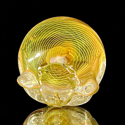 Decorative glass sphere with intricate patterns on a black background