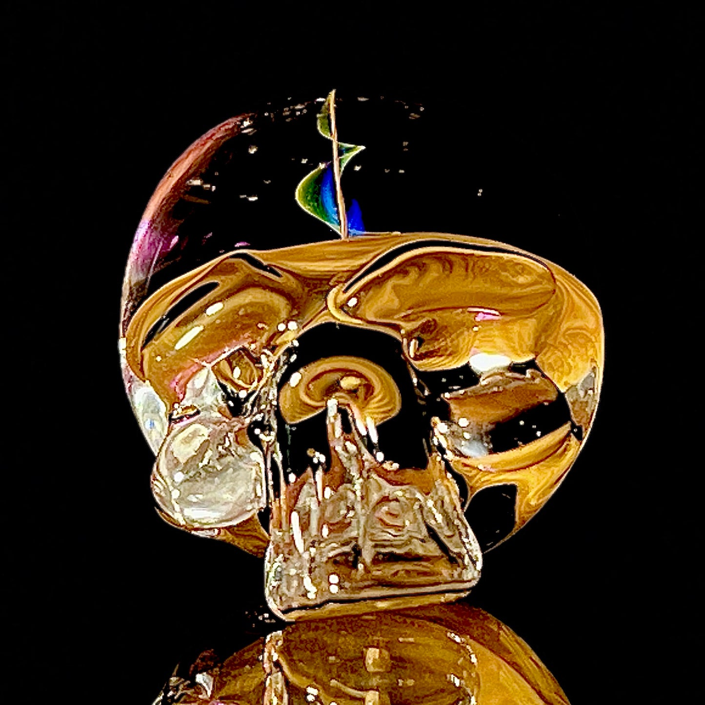 Gold skull figurine with a dark background.