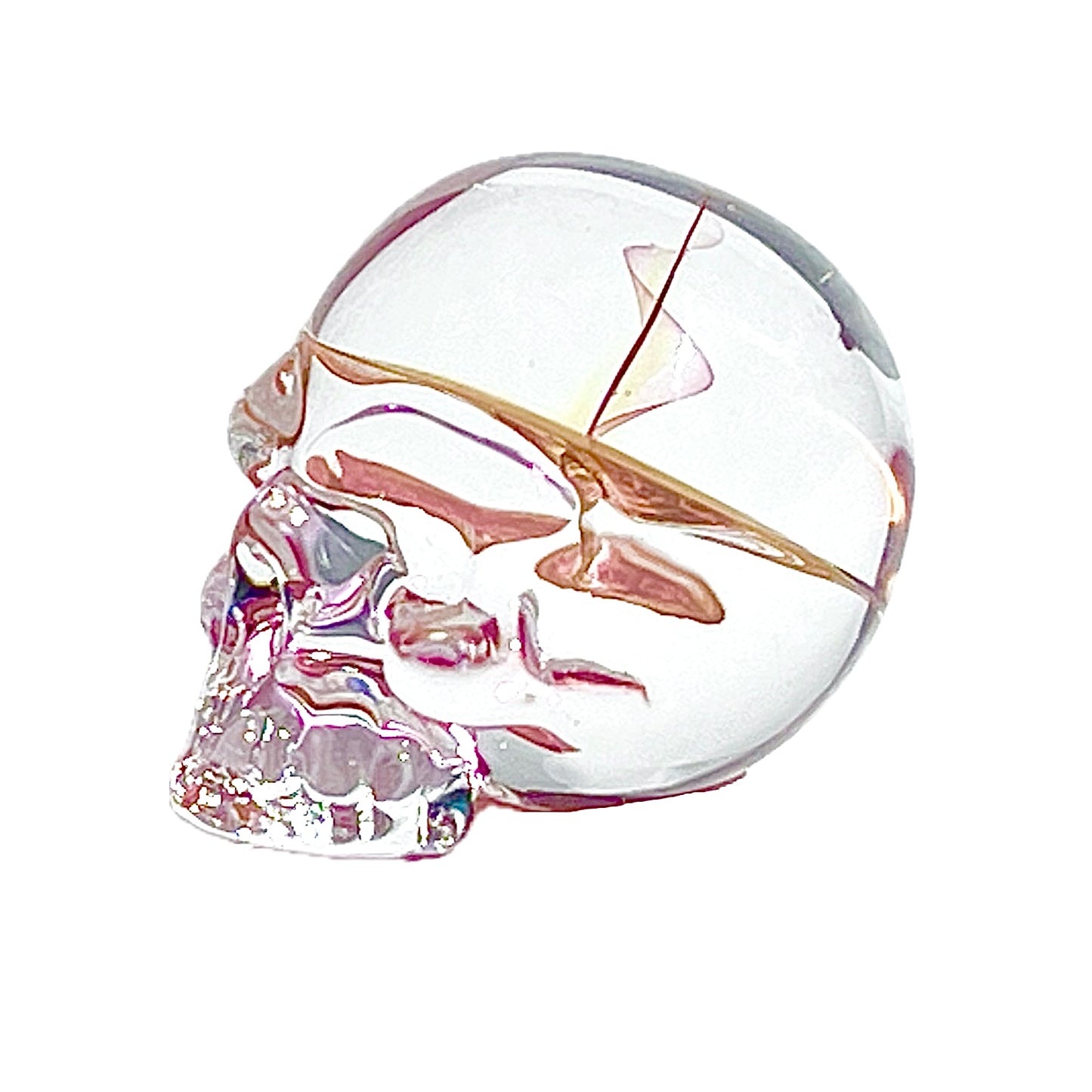 Glass skull with gold accents on a white background.