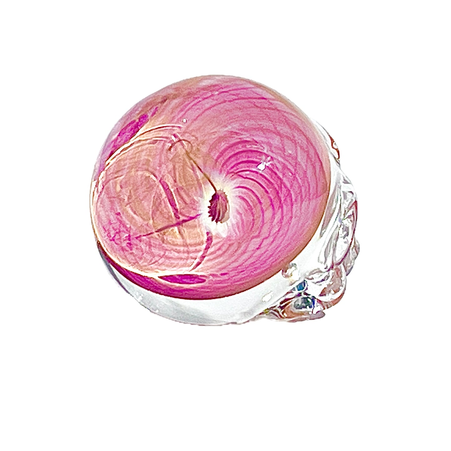 Pink and clear glass paperweight on a white background.