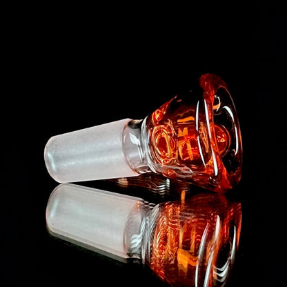 A glass slide with a curved orange bowl attached to a white stem.