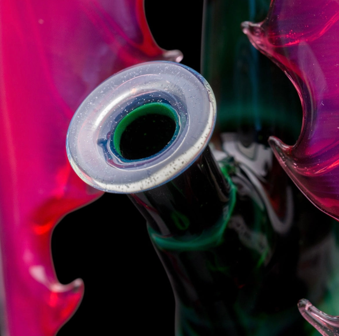 A custom glass piece by Joachim Dallant featuring a winged reaper figure with a colorful backdrop, incorporating a Fumicello orb and a removable scythe dabber.