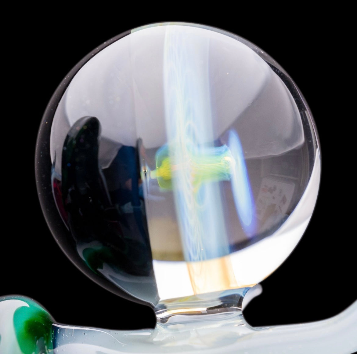 A custom glass piece by Joachim Dallant featuring a winged reaper figure with a colorful backdrop, incorporating a Fumicello orb and a removable scythe dabber.