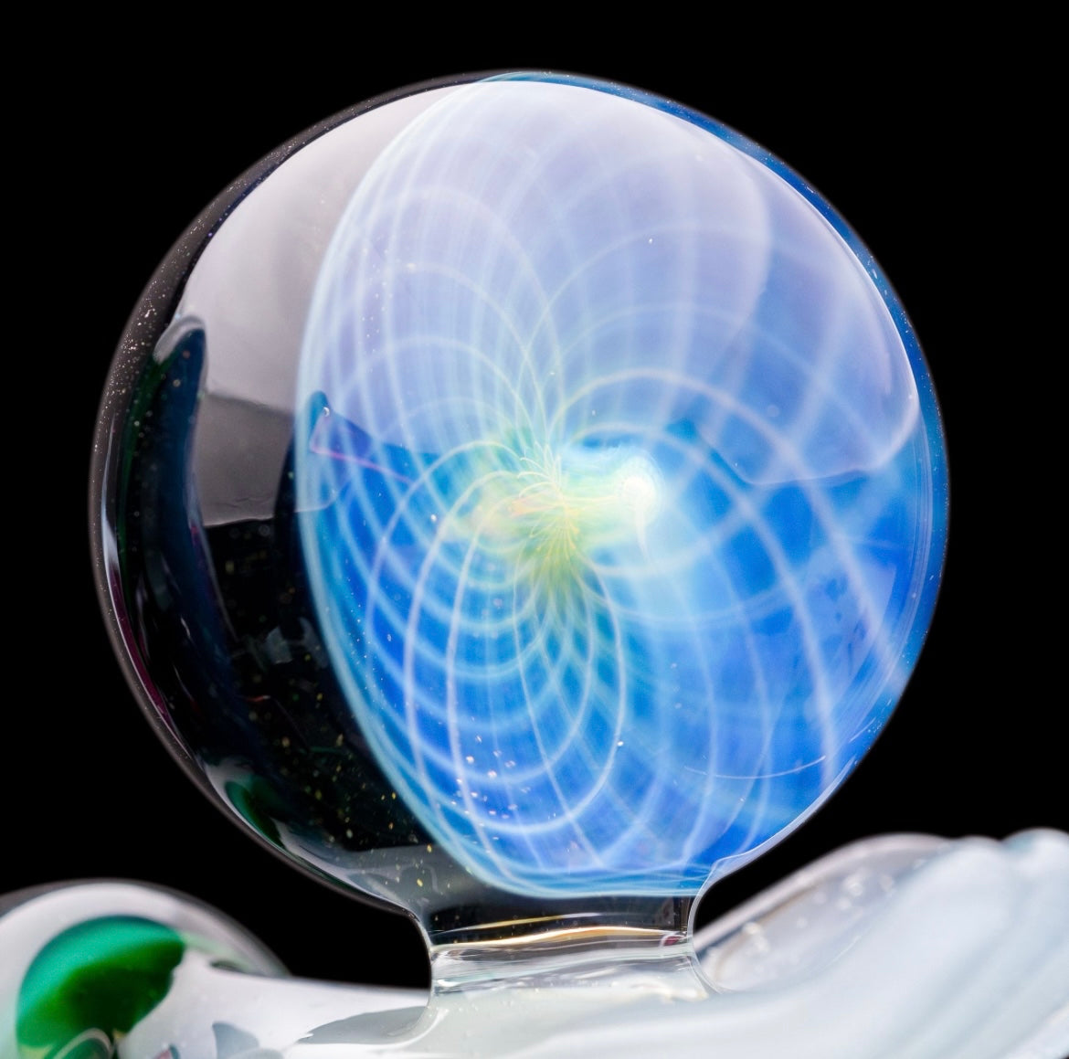 A custom glass piece by Joachim Dallant featuring a winged reaper figure with a colorful backdrop, incorporating a Fumicello orb and a removable scythe dabber.