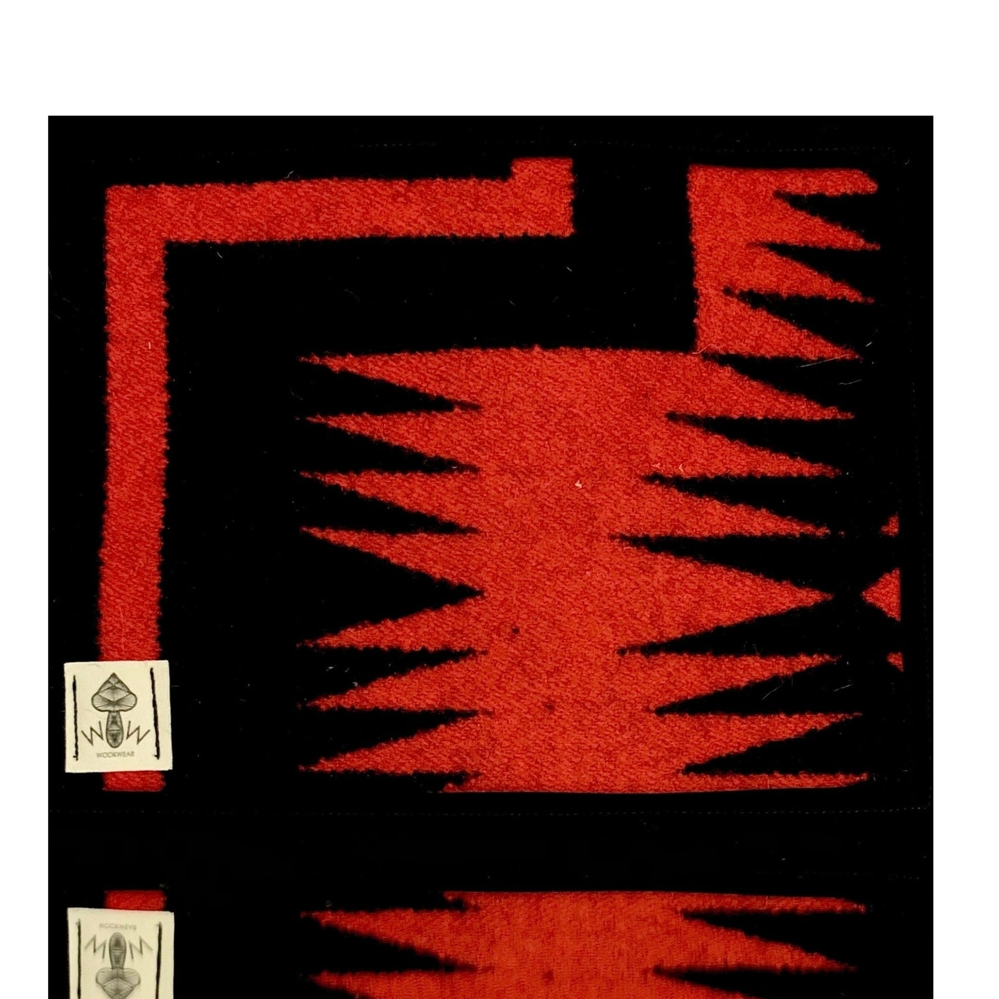 A black and red geometric patterned Pendleton mat.