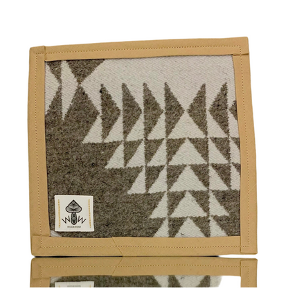 A rectangular Pendleton mat with a geometric pattern in beige and gray colors, featuring the Wook Wear logo.
