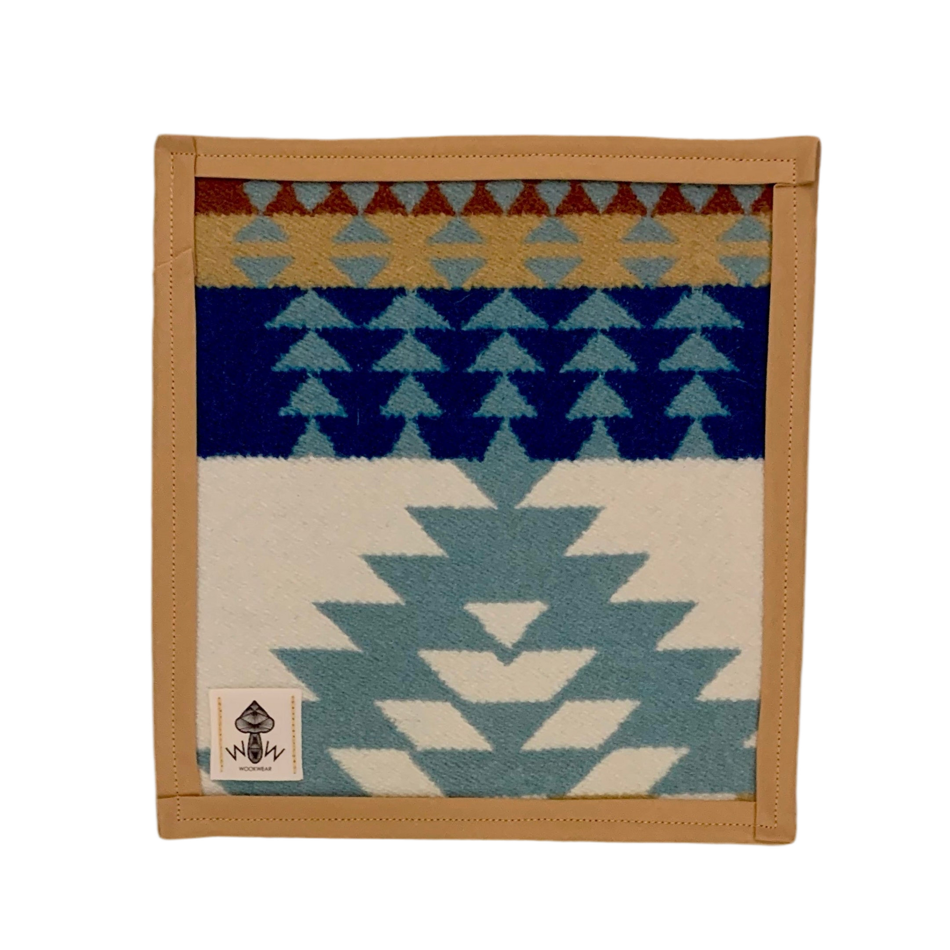 A rectangular Pendleton mat with geometric patterns in blue, beige, and multicolor, featuring the Wook Wear logo in the bottom left corner.