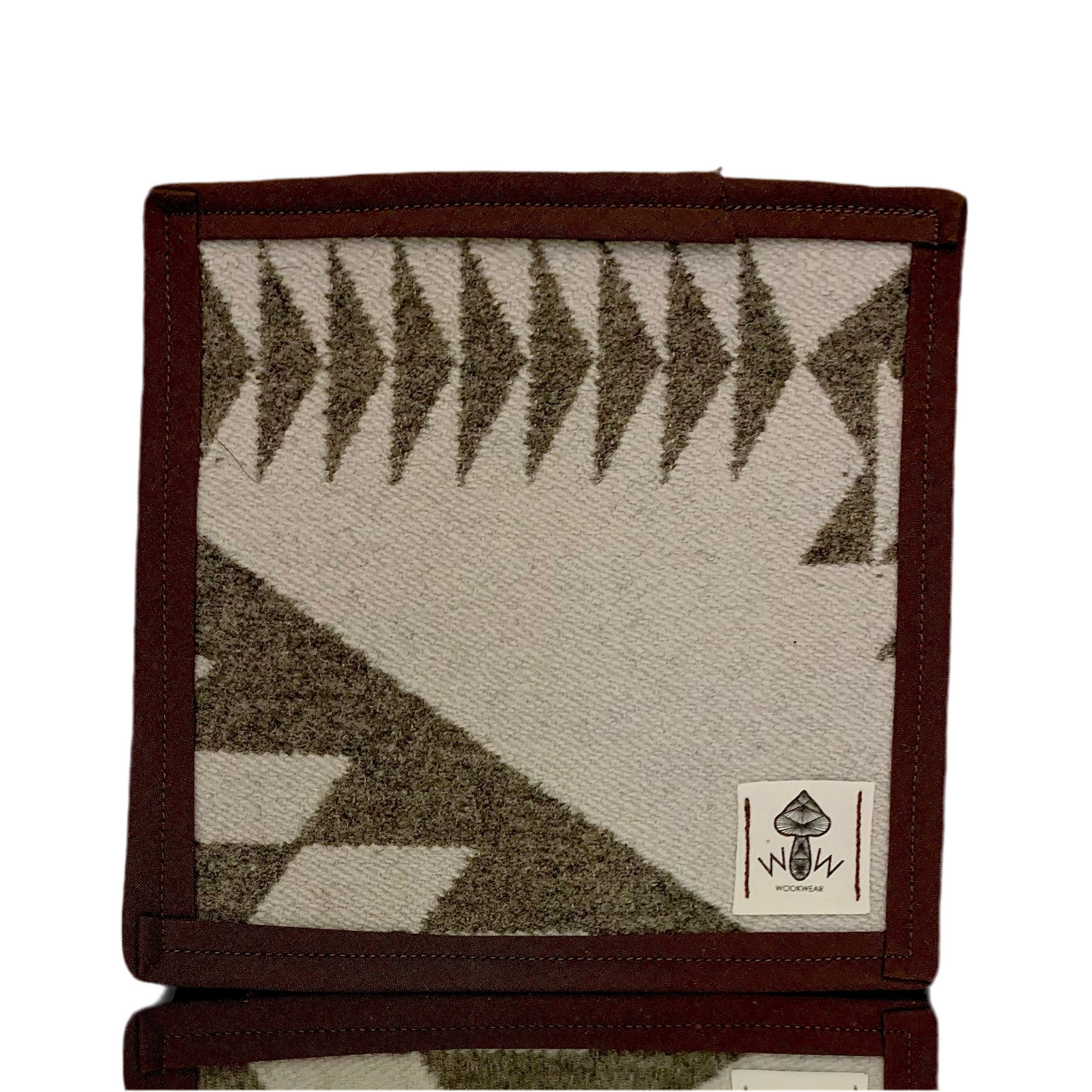 A rectangular Pendleton mat with a geometric pattern in beige and brown colors, featuring the Wook Wear logo.