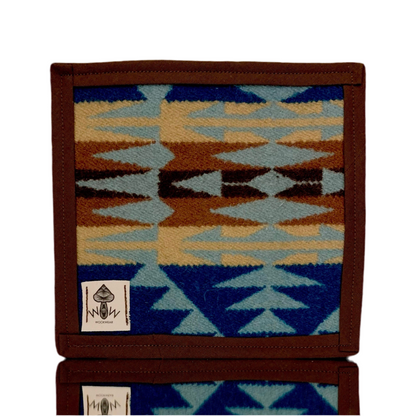 A upcycled fabric pen holder with a geometric pattern in blue, brown, and beige colors, featuring the Wook Wear brand label.